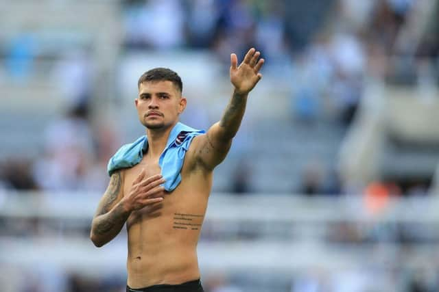 Newcastle United's Brazilian midfielder Bruno Guimaraes waves to fans at the end of the English Premier League football match between Newcastle United and Manchester City at St James' Park in Newcastle-upon-Tyne, north east England, on August 21, 2022.  (Photo by Lindsey Parnaby / AFP)