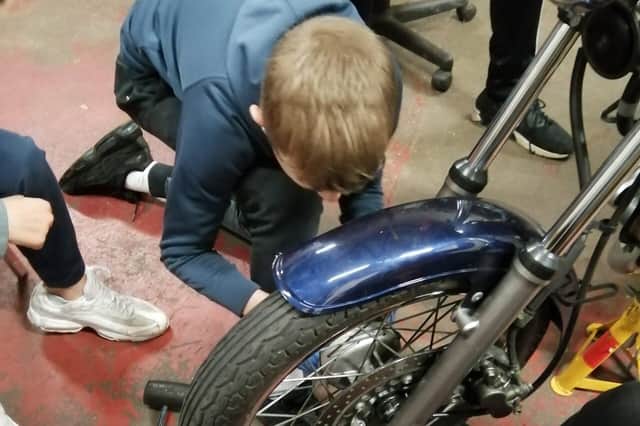 Young person working on a motorcycle