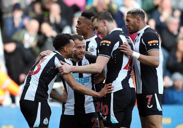 Jacob Murphy of Newcastle United congratulates team mate Ryan Fraser on his opening goal during the Premier League match between Newcastle United and Brighton & Hove Albion at St. James Park on March 05, 2022 in Newcastle upon Tyne, England. (Photo by Ian MacNicol/Getty Images)