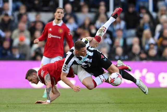 Wout Weghorst of Manchester United is tackled by Sven Botman of Newcastle United during the Premier League match between Newcastle United and Manchester United at St. James Park on April 02, 2023 in Newcastle upon Tyne, England. (Photo by Stu Forster/Getty Images)