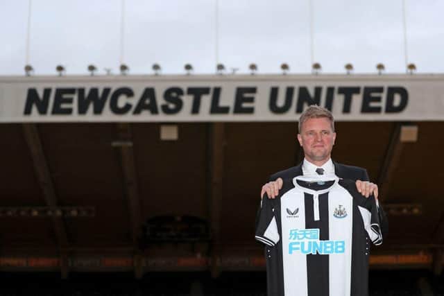 Newcastle United's newly appointed manager, Eddie Howe poses with a team shirt on the pitch at their St James' Park ground in Newcastle-upon-Tyne, north east England on November 10, 2021. (Photo by SCOTT HEPPELL/AFP via Getty Images)