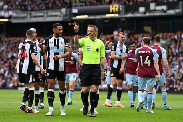 Craig Pawson indicates a VAR review for a penalty for Newcastle United during the Premier League match between Burnley and Newcastle United at Turf Moor on May 22, 2022 in Burnley, England. (Photo by Gareth Copley/Getty Images)