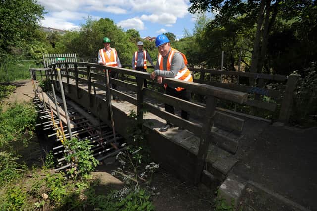 South Tyneside Council Cllr Ernest Gibson with ESH Civils contract manager Stephen McClean and project manager Steve Marshall, at the damaged Mill Dene footbridge over the River Don which is to be replaced.