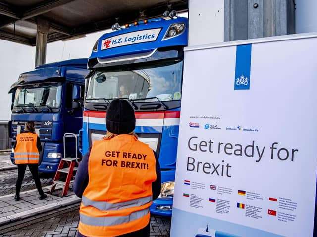 Flyers are distributed, as part of the Get Ready For Brexit campaign, to truck drivers at the terminal of a ferry operator in the port of Rotterdam on December 1, 2020.