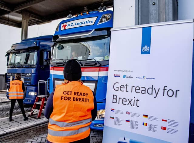 Flyers are distributed, as part of the Get Ready For Brexit campaign, to truck drivers at the terminal of a ferry operator in the port of Rotterdam on December 1, 2020.