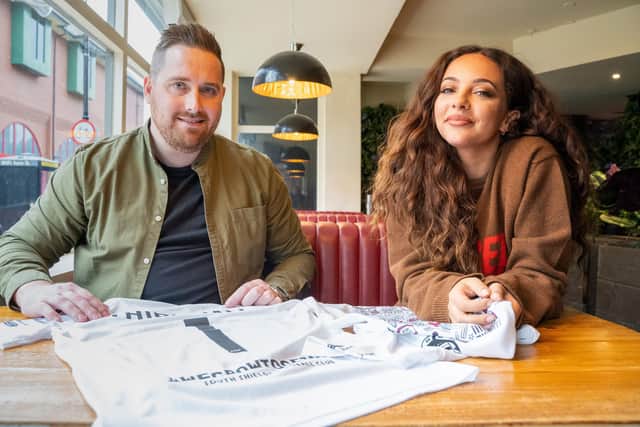 Jade and James contemplating the shirt designs from a table in her Arbeia bar in Ocean Road.