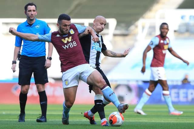 John McGinn challenges Jonjo Shelvey.