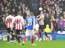 Sunderland's Tom Flanagan, right, gets the better of Portsmouth's John Marquis in this aerial battle - but Marquis had the last laugh.