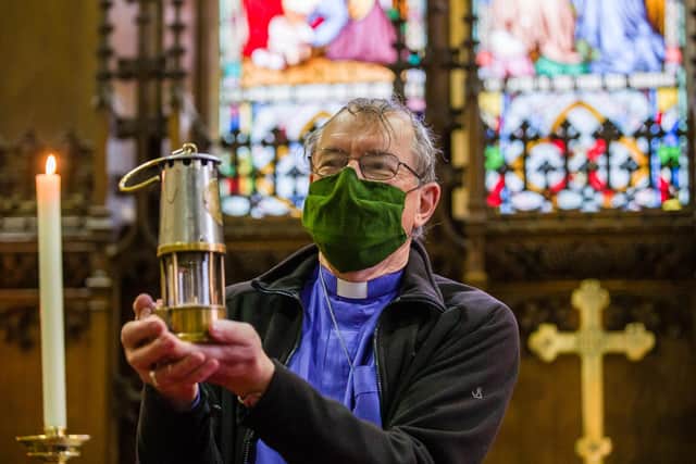 Bishop Paul holds a Davy Lamp which was developed at the instigation of a vicar in the Diocese after the Felling Mine Disaster of 1812 and tested in Hebburn Colliery in 1816.