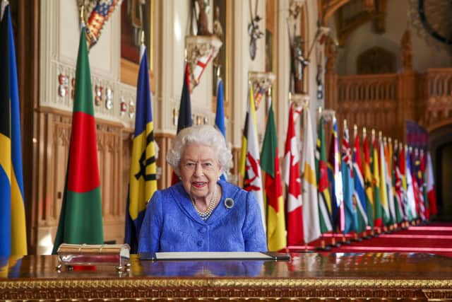 Queen Elizabeth II signs her annual Commonwealth Day Message in St George's Hall at Windsor Castle.