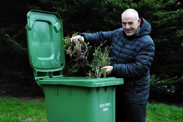 Cllr Gibson with a green bin.