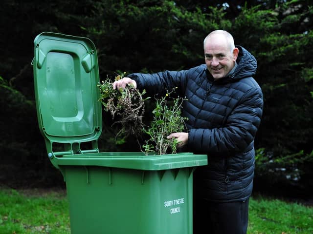 Cllr Gibson with a green bin.