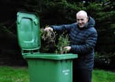 Cllr Gibson with a green bin.