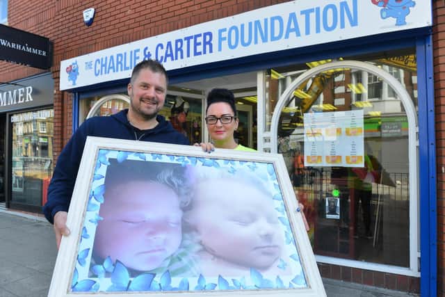 Sarah and Chris Cookson outside their charity's shop.