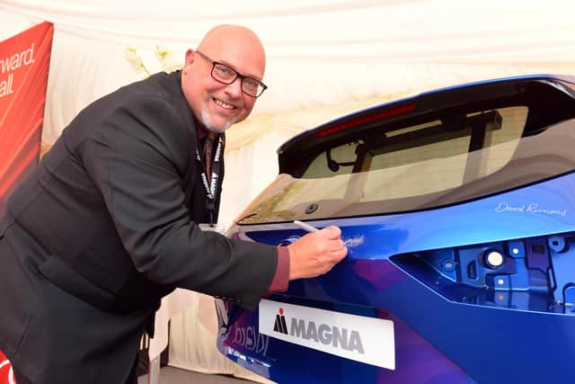 Coun Graeme Miller signs a Qashqai tailgate to mark the opening