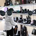 Stock image of a woman browsing in a shop.