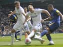 Rasmus Kristensen puts a foot out to try to deny Newcastle striker Callum Wilson.