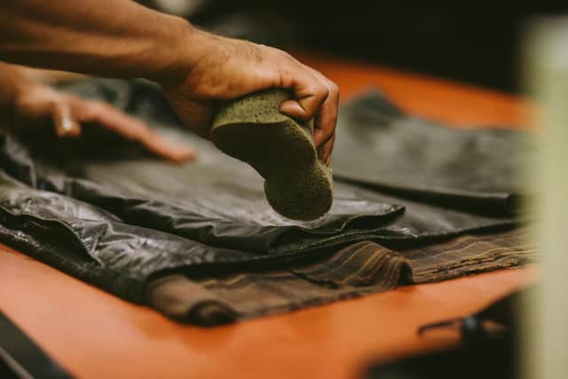 Barbour Rewaxing Service - Wax is applied with a sponge to the back of a Barbour jacket