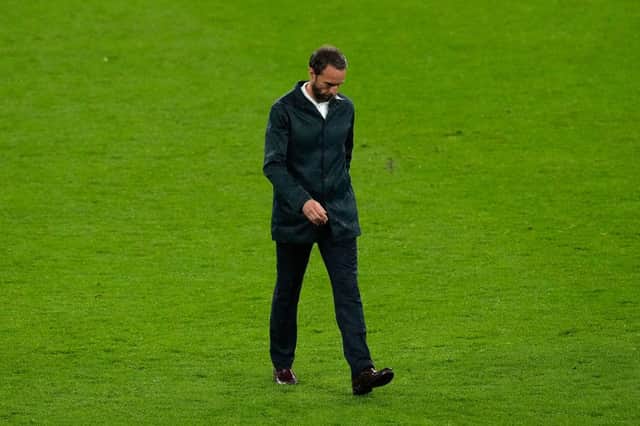 Gareth Southgate, Head Coach of England looks dejected as he walks across the pitch.