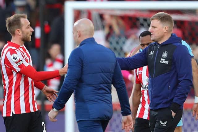 Brentford's Danish midfielder Christian Eriksen is congratulated by Newcastle United's English head coach Eddie Howe (R) after the English Premier League football match between Brentford and Newcastle United at Brentford Community Stadium in London on February 26, 2022. (Photo by GEOFF CADDICK/AFP via Getty Images)