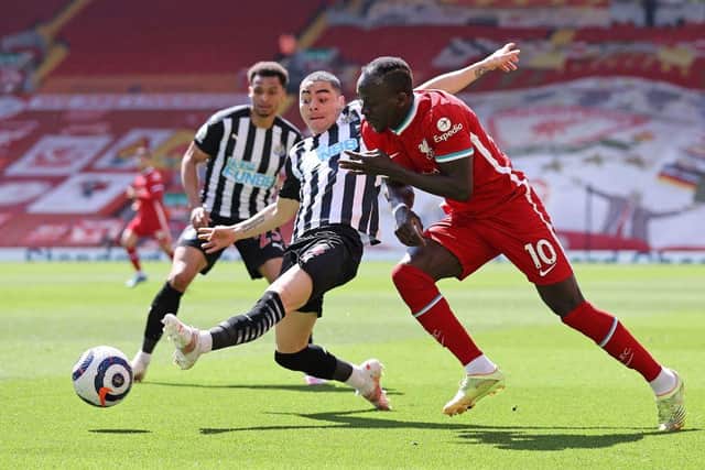 Newcastle United's Paraguayan midfielder Miguel Almiron (C) vies with Liverpool's Senegalese striker Sadio Mane during the English Premier League football match between Liverpool and Newcastle United at Anfield in Liverpool, north west England on April 24, 2021.