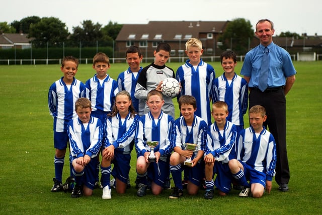 The trophy-winning under-11 team from the school with their coach David Russell in 2003.