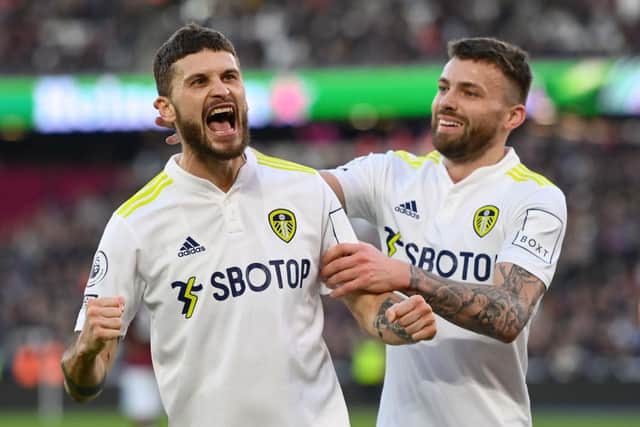Mateusz Klich of Leeds United celebrates with Stuart Dallas before having his goal disallowed during the Premier League match between West Ham United  and  Leeds United at London Stadium on January 16, 2022 in London, England. (Photo by Mike Hewitt/Getty Images)