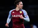 Jack Grealish of Aston Villa looks on during the Premier League match between Brighton & Hove Albion and Aston Villa at American Express Community Stadium on February 13, 2021 in Brighton, England. Sporting stadiums around the UK remain under strict restrictions due to the Coronavirus Pandemic as Government social distancing laws prohibit fans inside venues resulting in games being played behind closed doors.