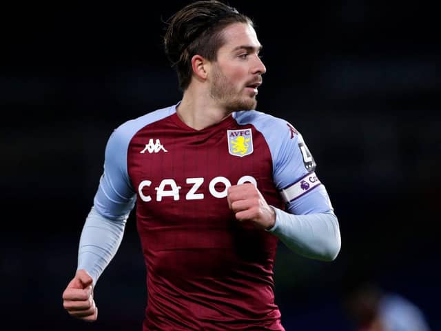 Jack Grealish of Aston Villa looks on during the Premier League match between Brighton & Hove Albion and Aston Villa at American Express Community Stadium on February 13, 2021 in Brighton, England. Sporting stadiums around the UK remain under strict restrictions due to the Coronavirus Pandemic as Government social distancing laws prohibit fans inside venues resulting in games being played behind closed doors.