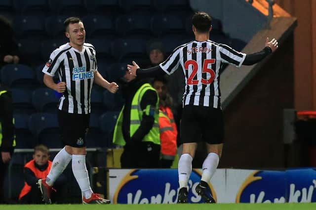 Newcastle United's English midfielder Callum Roberts (L) celebrates with Newcastle United's English defender Jamie Sterry after scoring their second goal during the English FA Cup third round replay football match between Blackburn Rovers and Newcastle United at Ewood Park in Blackburn, north west England on January 15, 2019. (Photo by Lindsey PARNABY / AFP) / RESTRICTED TO EDITORIAL USE. No use with unauthorized audio, video, data, fixture lists, club/league logos or 'live' services. Online in-match use limited to 120 images. An additional 40 images may be used in extra time. No video emulation. Social media in-match use limited to 120 images. An additional 40 images may be used in extra time. No use in betting publications, games or single club/league/player publications. /         (Photo credit should read LINDSEY PARNABY/AFP via Getty Images)