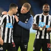Newcastle United's Paraguayan midfielder Miguel Almiron (L), Newcastle United's English head coach Eddie Howe (C) and Newcastle United's French midfielder Allan Saint-Maximin (R) celebrate on the pitch after the English Premier League football match between Leicester City and Newcastle United at King Power Stadium in Leicester, central England on December 26, 2022. (Photo by LINDSEY PARNABY/AFP via Getty Images)