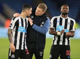 Newcastle United's Paraguayan midfielder Miguel Almiron (L), Newcastle United's English head coach Eddie Howe (C) and Newcastle United's French midfielder Allan Saint-Maximin (R) celebrate on the pitch after the English Premier League football match between Leicester City and Newcastle United at King Power Stadium in Leicester, central England on December 26, 2022. (Photo by LINDSEY PARNABY/AFP via Getty Images)