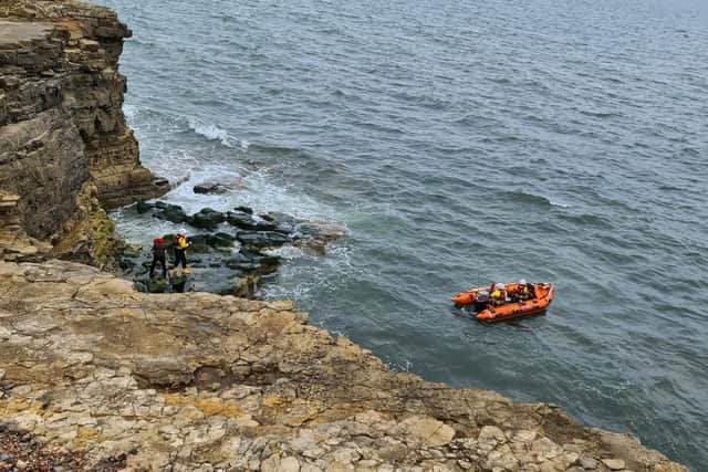 Once close enough to the rocks a member of the RNLI crew had to take the man and his dog to the boat where the pair were brought to safety. 

Photo by Sunderland Coastguard Rescue Team.