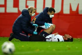 HEVERLEE, BELGIUM - NOVEMBER 15: Ben Chilwell of England receives medical treatment during the UEFA Nations League group stage match between Belgium and England at King Power at Den Dreef Stadion on November 15, 2020 in Heverlee, Belgium. Football Stadiums around Europe remain empty due to the Coronavirus Pandemic as Government social distancing laws prohibit fans inside venues resulting in fixtures being played behind closed doors. (Photo by Dean Mouhtaropoulos/Getty Images)