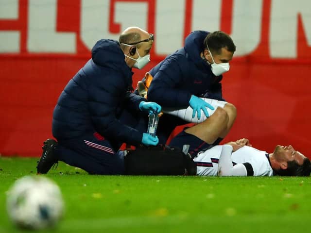 HEVERLEE, BELGIUM - NOVEMBER 15: Ben Chilwell of England receives medical treatment during the UEFA Nations League group stage match between Belgium and England at King Power at Den Dreef Stadion on November 15, 2020 in Heverlee, Belgium. Football Stadiums around Europe remain empty due to the Coronavirus Pandemic as Government social distancing laws prohibit fans inside venues resulting in fixtures being played behind closed doors. (Photo by Dean Mouhtaropoulos/Getty Images)