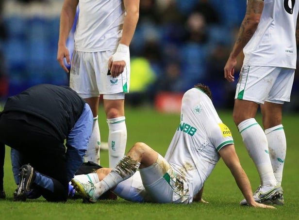 Newcastle United's Scottish midfielder Matt Ritchie receives medical treatment during the English FA Cup third round football match between Sheffield Wednesday and Newcastle United at Hillsborough Stadium in Sheffield, northern England on January 7, 2023. (Photo by LINDSEY PARNABY/AFP via Getty Images)