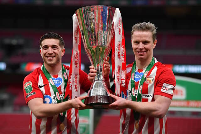 Lynden Gooch of Sunderland and Grant Leadbitter pose with the trophy.