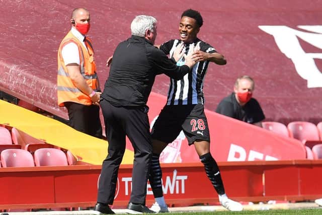 Newcastle United head coach Steve Bruce pictured celebrating with Joe Willock, who scored a late equaliser at Liverpool. (Photo by PAUL ELLIS/POOL/AFP via Getty Images)