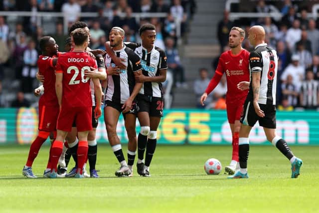 Joelinton of Newcastle United clashes with Diogo Jota of Liverpool during the Premier League match between Newcastle United and Liverpool at St. James Park on April 30, 2022 in Newcastle upon Tyne, England. (Photo by Ian MacNicol/Getty Images)