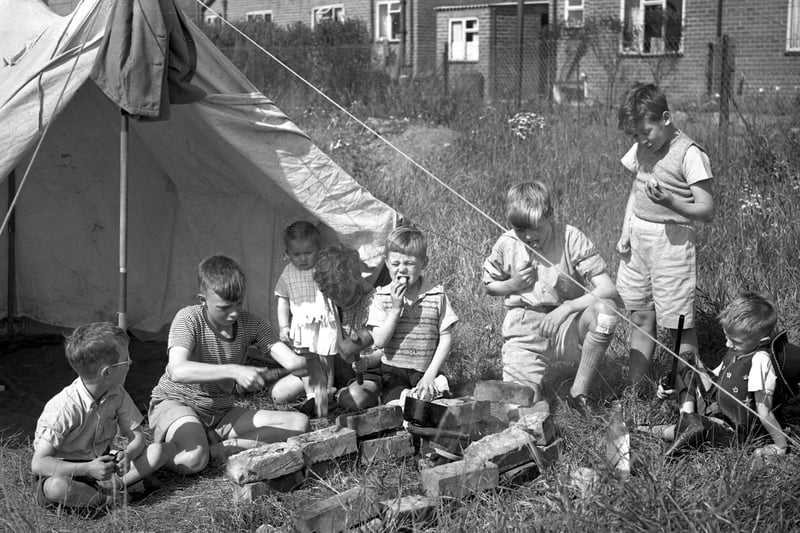 These young Wearsiders enjoy an early lunch of new potatoes at their camp near South Hylton in August 1954. 
Nicky Brown remembered: "Camping in a murky green ridge tent up at Westgate for the whole shipyard fortnight. Went the same place every year. There was next to nowt there bar a couple of swings and the river. There was always at least one thunderstorm, whereupon we were warned not to touch the sides of the tent. We would be sat near the sides, hands behind our backs, daring ourselves to touch the sides to see what would happen."