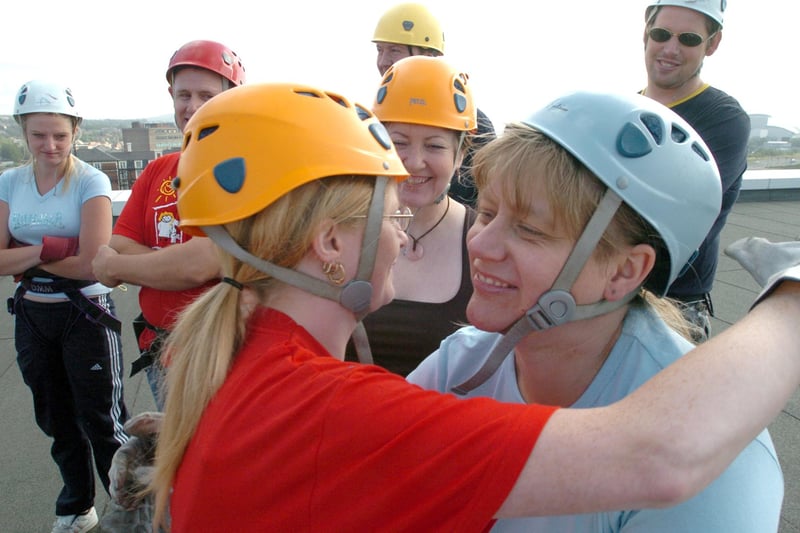 A hug for friends from Sharon Eades McBride, red top, before she set off from the roof of the Bristol Hotel for a charity abseil in 2006