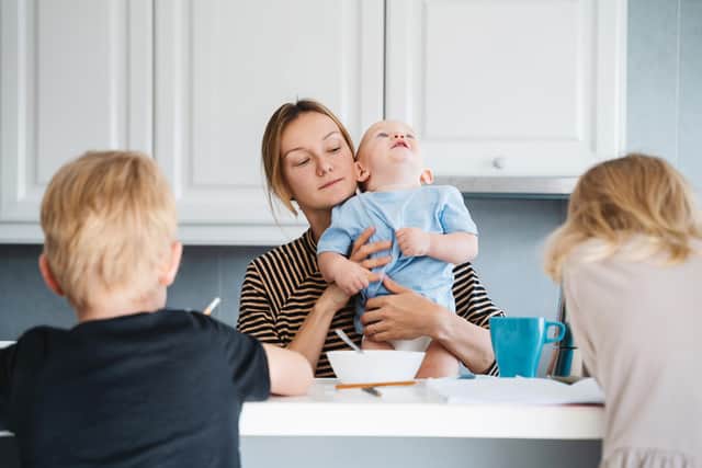 A mother with three children, who would be impacted by the two-child limit. Photo posed by models