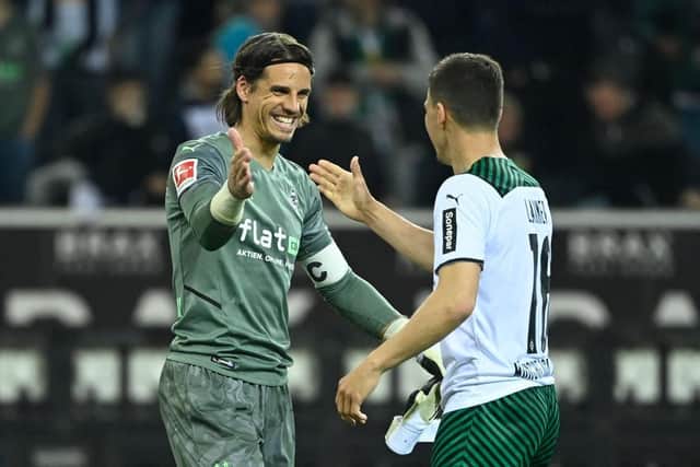 Moenchengladbach's Swiss goalkeeper Yann Sommer (L) celebrates the team's win with Moenchengladbach's Austrian defender Stefan Lainer after the German first division Bundesliga football match between Borussia Moenchengladbach and RB Leipzig in Mönchengladbach, western Germany on May 2, 2022.  (Photo by INA FASSBENDER/AFP via Getty Images)