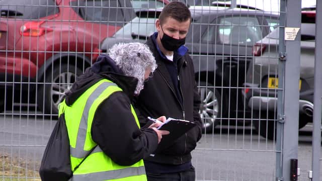 People queue for the vaccination centre at the Essa Academy in Bolton. The Indian coronavirus variant has been detected in a number of areas in England, including Bolton, which are reporting the highest rates of infection, data suggests. Picture date: Friday May 14, 2021.