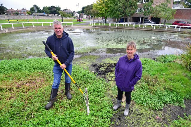 Residents Gary Johnston, 52, and Belinda Gibbs, 53, standing in Whitburn Pond before the dredging took place.
Picture by FRANK REID