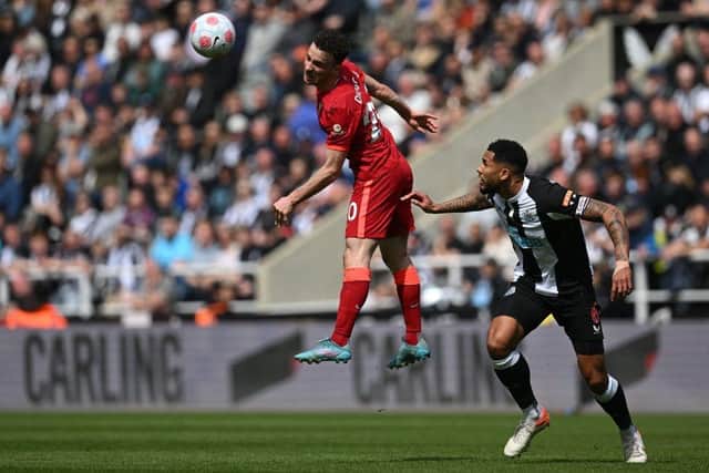 Liverpool's Portuguese striker Diogo Jota (L) fights for the ball with Newcastle United's English defender Jamaal Lascelles (R) during the English Premier League football match between Newcastle United and Liverpool at St James' Park in Newcastle-upon-Tyne, north east England on April 30, 2022. (Photo by PAUL ELLIS/AFP via Getty Images)