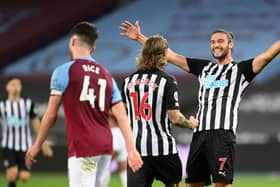 Newcastle United's English striker Andy Carroll (R) reacts after Newcastle United's Irish midfielder Jeff Hendrick (C) scored their second goal during the English Premier League football match between West Ham United and Newcastle United at The London Stadium, in east London on September 12, 2020.