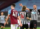 Newcastle United's English striker Andy Carroll (R) reacts after Newcastle United's Irish midfielder Jeff Hendrick (C) scored their second goal during the English Premier League football match between West Ham United and Newcastle United at The London Stadium, in east London on September 12, 2020.