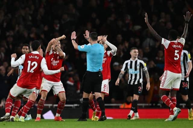 Arsenal players appeal to Referee Andy Madley during the English Premier League football match between Arsenal and Newcastle United at the Emirates Stadium in London on January 3, 2023. (Photo by BEN STANSALL/AFP via Getty Images)