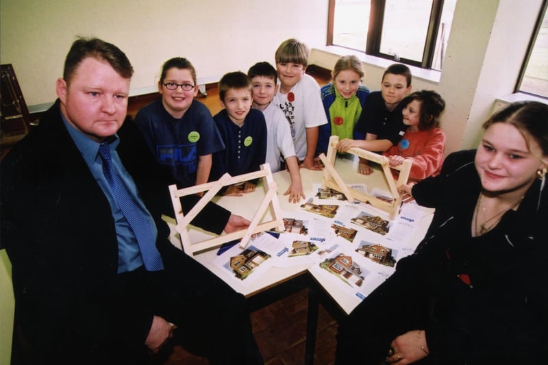 Ben Bailey Homes, Apprentice Supervisor, Alan Betney (left) and Michelle Spall with local children at the Safe as House projects 2000 at Doncaster College's construction game in 2002
